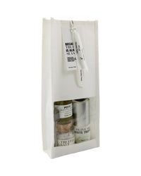 Nicolas Vahé truffle gift bag, white windowed bag with hang tag showing truffle pesto, salt and oil inside