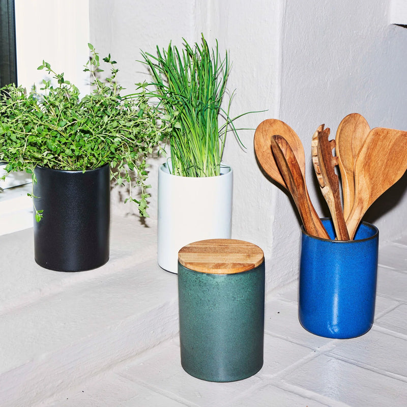 northern green stoneware canister with teak lid by aida in a styled kitchen setting