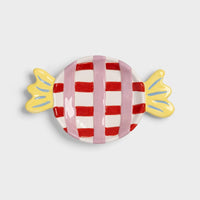 Candy-shaped dish with red and white checkered design on a light gray background