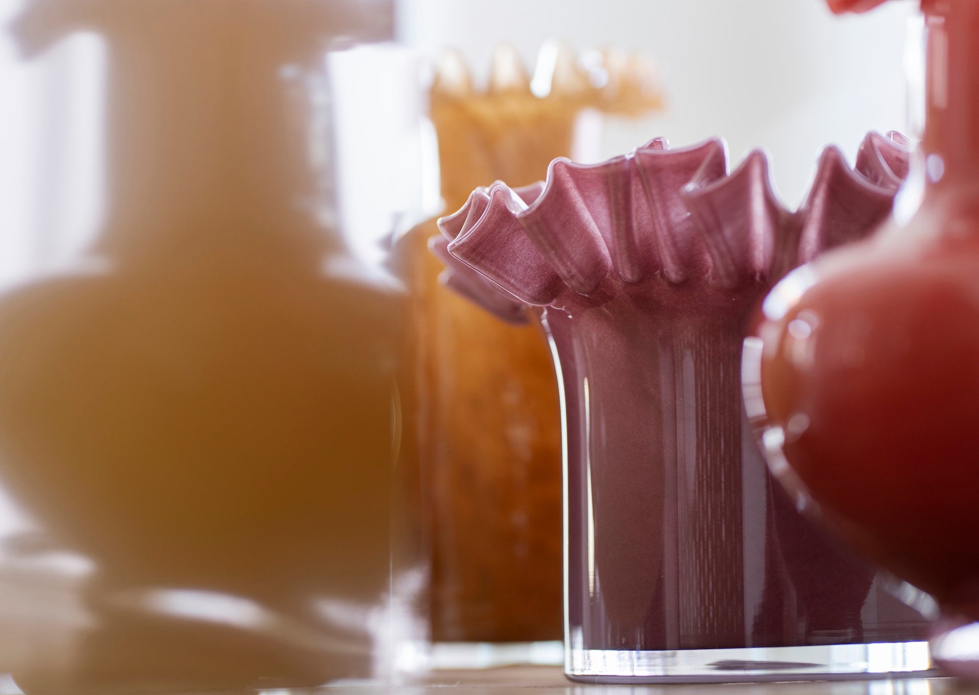 plum ruffle edge glass flower pot styled in warm interior
