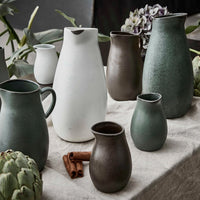 northern green stoneware decanter by aida on a table with matching RAW ceramics
