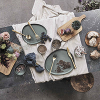 northern green RAW organic bowl by aida styled on a layered table setting with matching ceramics
