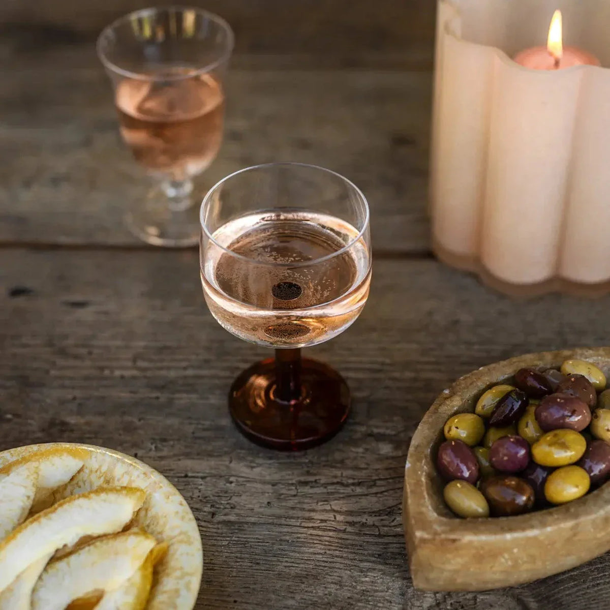 Rio wine glasses by Olsson & Jensen with rosé on a rustic table