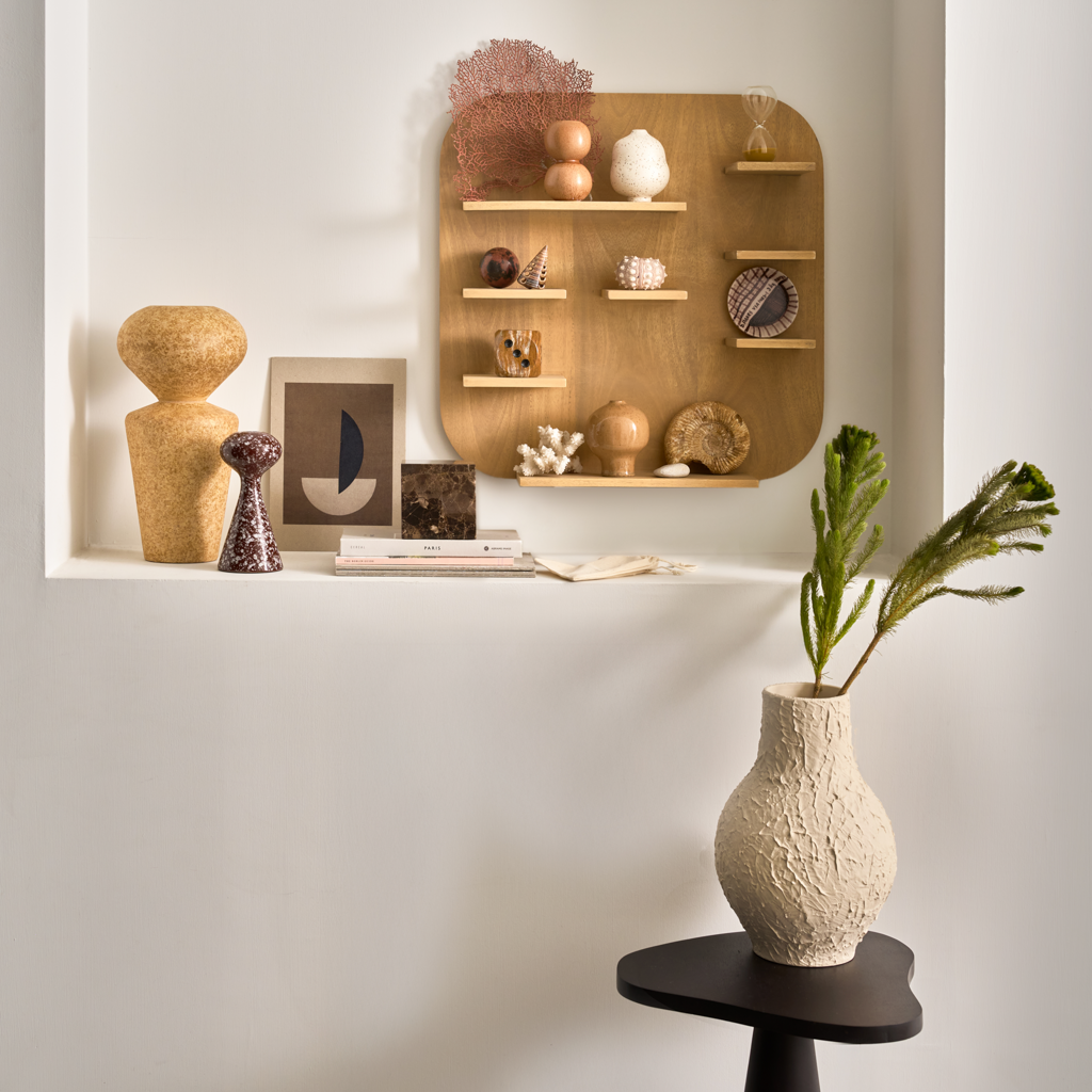 Urban Nature Culture ceramics styled in a wall niche with a vase of greenery