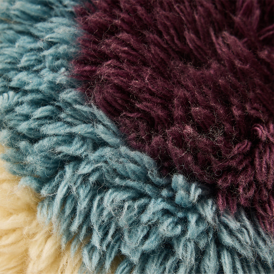 close up of fluffy HKLIVING cushion showing multicolour wool fibres and handcrafted texture
