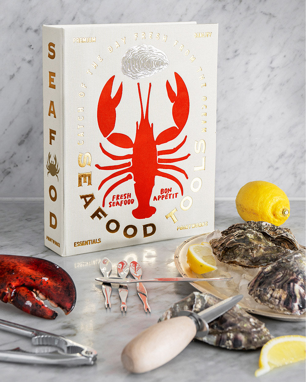 Seafood Tools set displayed with lemons and oysters on ice