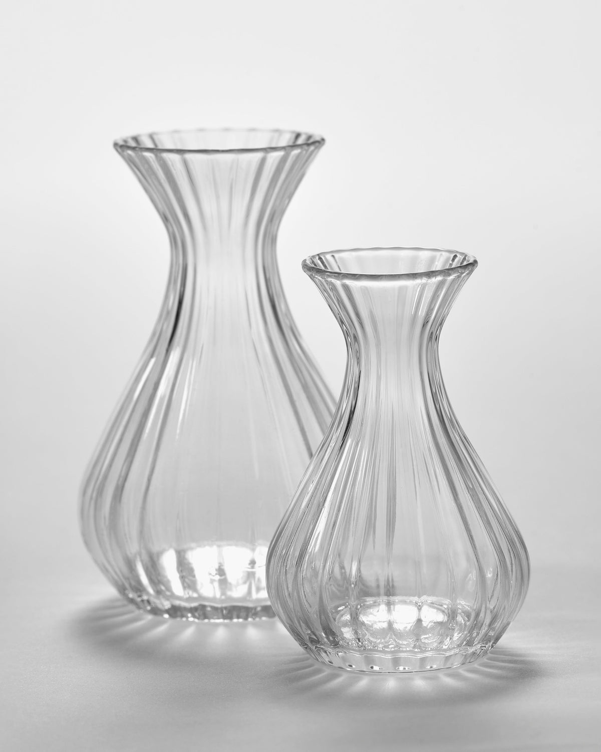 Serax Inku ribbed glass carafes in small and extra small sizes side by side
