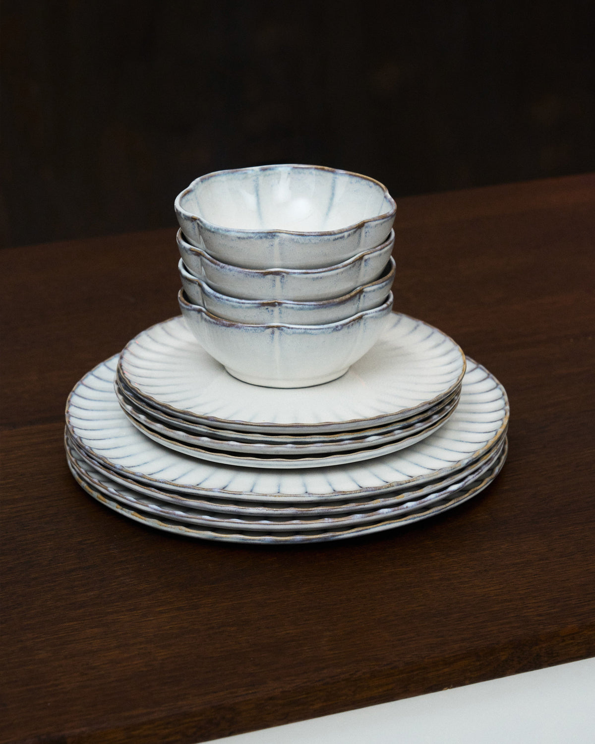 Inku white tableware by Sergio Herman for Serax stacked on a dark surface