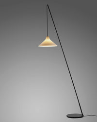 Serax Seam floor lamp switched on, glowing porcelain shade against a grey backdrop