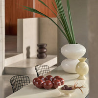 Sisko bowl on a dining table beside cream stacked vases