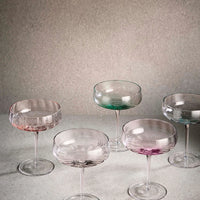 Set of colorful glass cocktail glasses from Aida SØHOLM Sonja collection on a neutral background