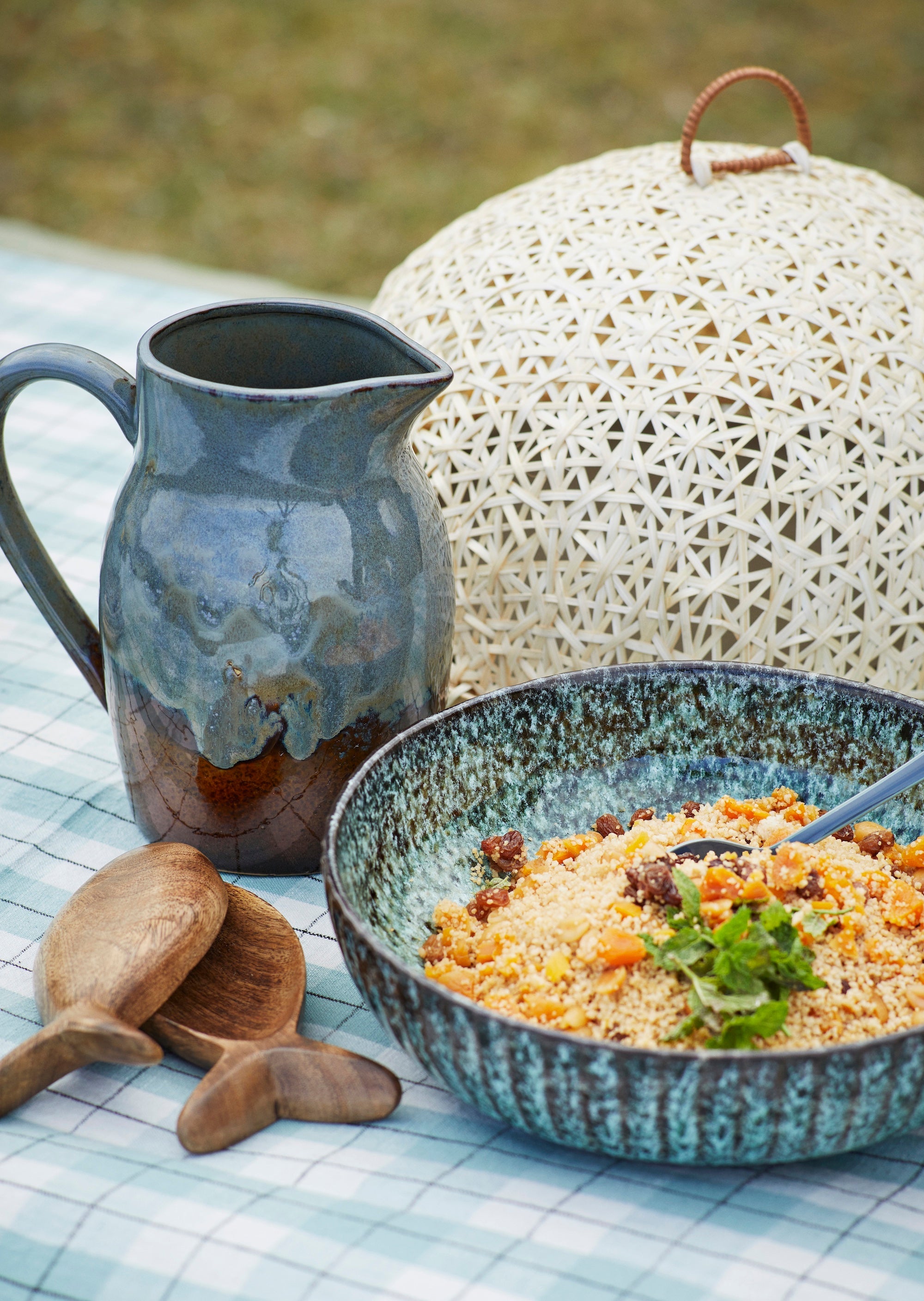 petrol green reactive glaze serving bowl filled with couscous outdoors
