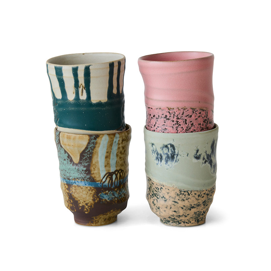 Set of four tall stoneware mugs by hkliving with mixed finishes.