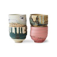 Stoneware coffee cup set highlighting organic shapes and raw edges.
