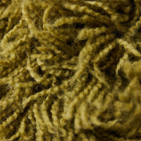 Close-up of olive green shaggy cushion on sofa, fluffy wool blend texture by HKLIVING
