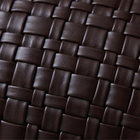 Close-up of woven basket-weave texture on chocolate brown faux leather cushion