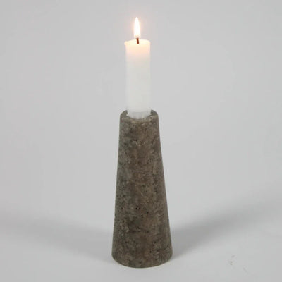 Dark travertine cone candle holder by Olsson & Jensen with a white candle