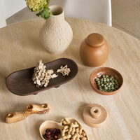 Urban Nature Culture ceramics and wooden bowls styled on a round dining table