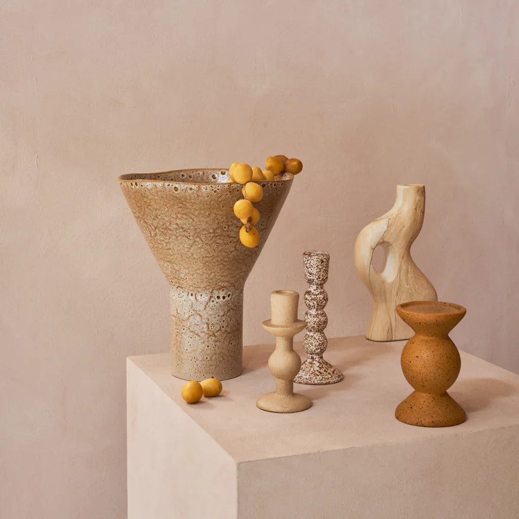Yaro vase with dried flowers styled on a plinth with sculptural candle holders