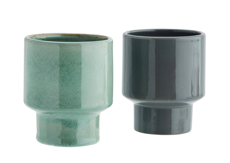 green and grey stoneware cups with modern silhouette and smooth glaze finish, side by side
