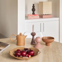 Zaria candle holder styled on a dining table with a bowl of cherries and a teapot