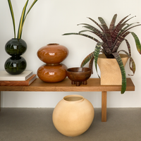 Urban Nature Culture vases styled on a low wooden bench with plants